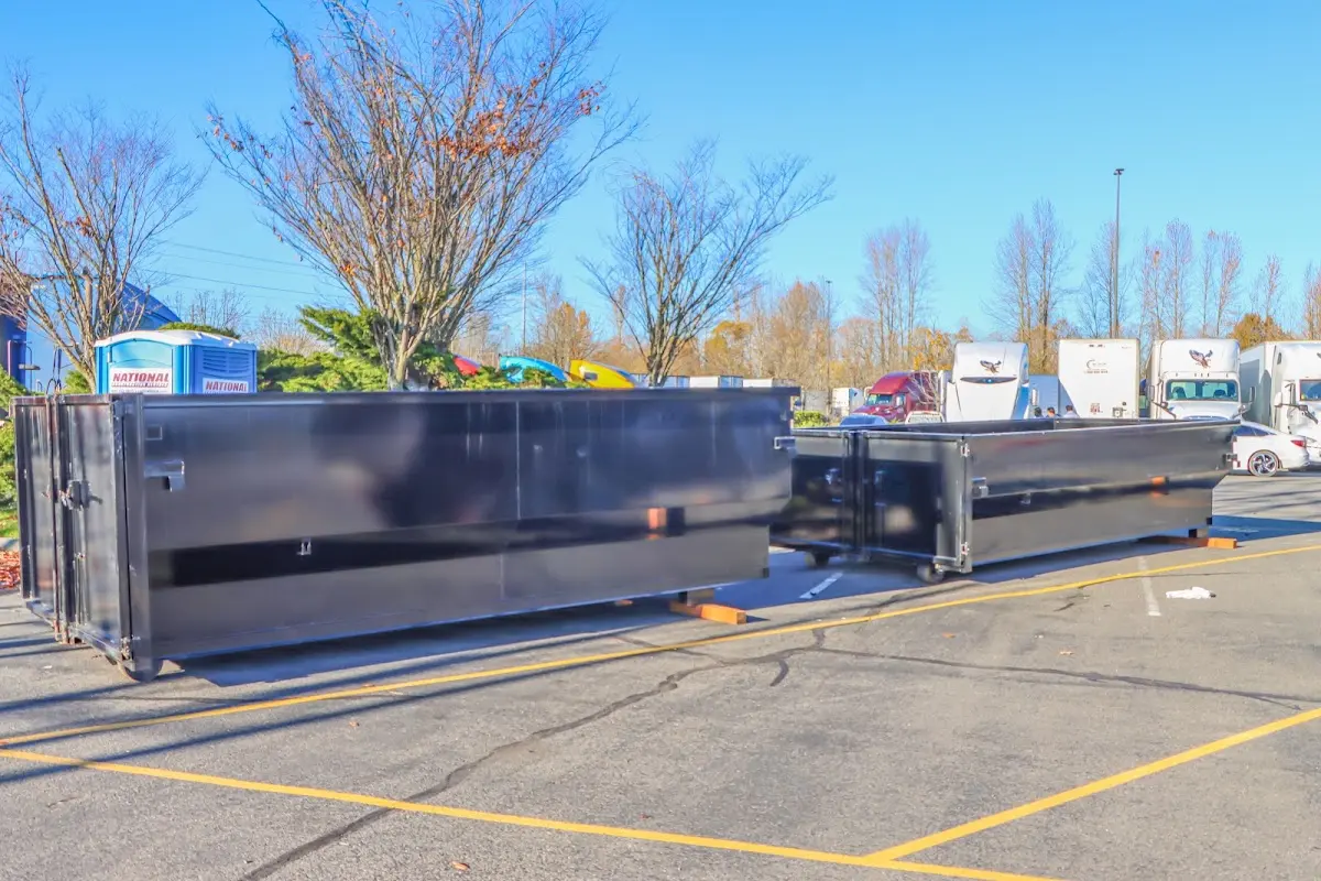 Professional dumpster rental service with roll-off container on residential driveway in Brown Deer